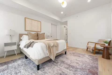 a bedroom with a bed and chair