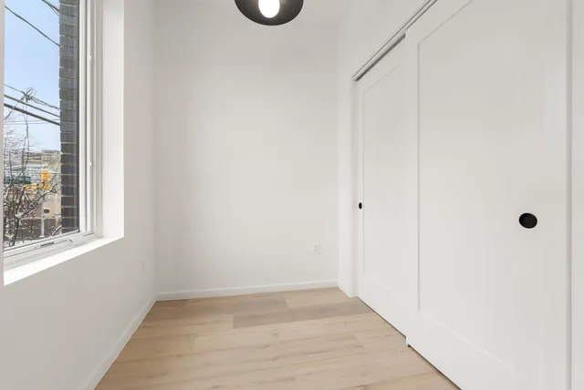 a view of an empty room with a window