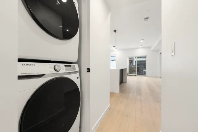 a view of a kitchen with a sink and a washer dryer