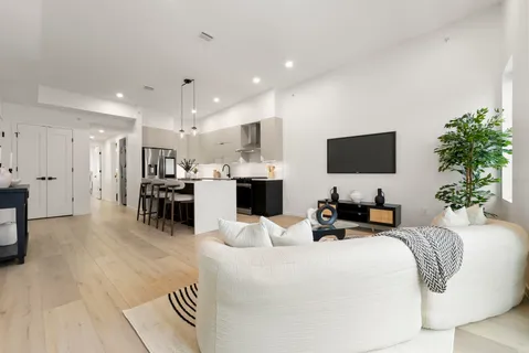 a living room with fireplace furniture and a flat screen tv