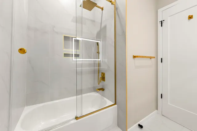 a bathroom with a bathtub and a shower