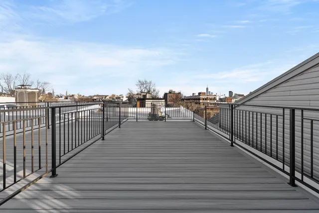 a view of a balcony with wooden floor with city view