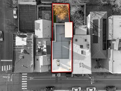 an aerial view of residential houses with outdoor space