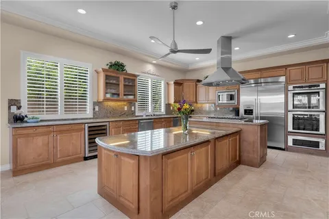 a kitchen with stainless steel appliances granite countertop a stove a sink and a refrigerator