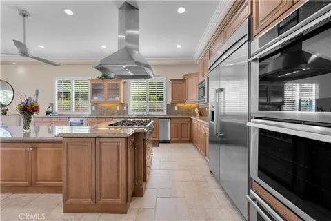 a bedroom with a large bed a flat tv screen and a fireplace