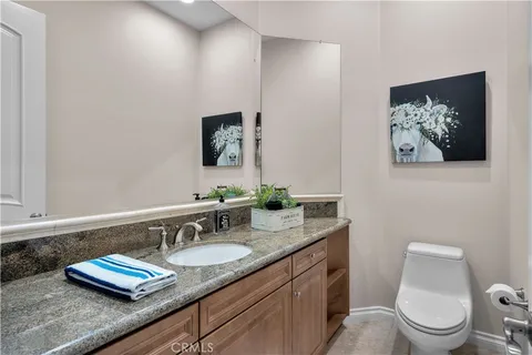 a view of a house with a big yard and palm trees