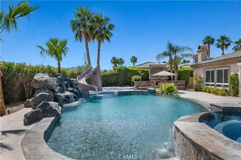 a bathroom with a granite countertop sink and a toilet