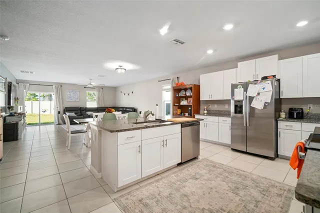 a kitchen with sink cabinets and stainless steel appliances