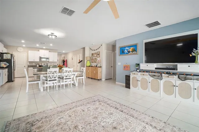 a view of a dining room with furniture and a flat screen tv