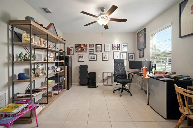 a view of a workspace with furniture and a window