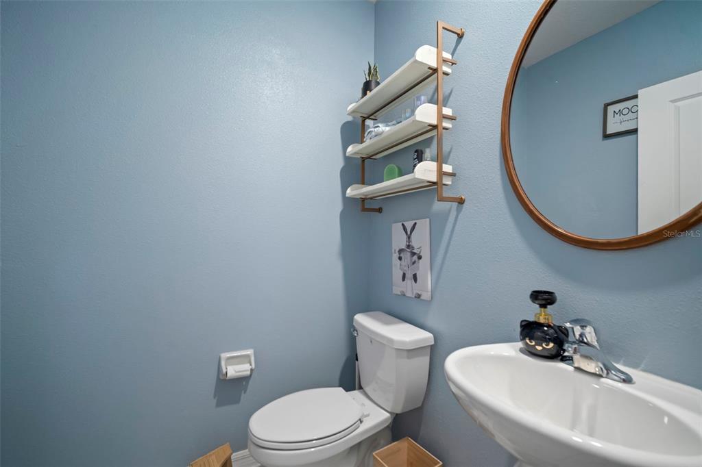 5430 Blue Azure Drive Wimauma, FL 33598 - Photo 32 of 46 a white toilet sitting next to a bathroom sink