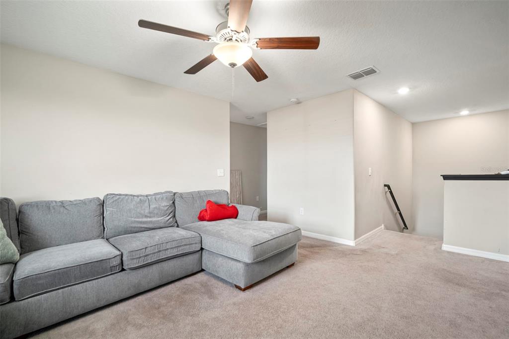 5430 Blue Azure Drive Wimauma, FL 33598 - Photo 34 of 46 a living room with furniture and a ceiling fan