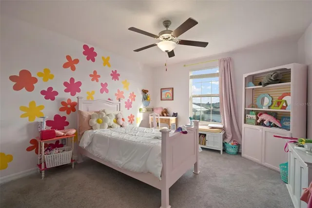 a bedroom with bed and a chandelier