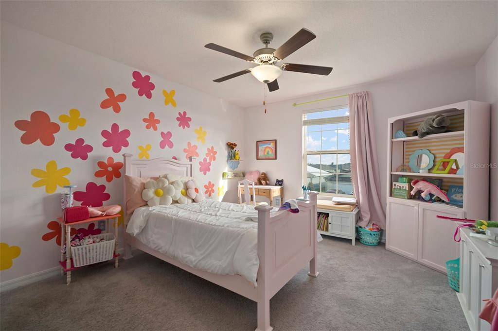 5430 Blue Azure Drive Wimauma, FL 33598 - Photo 37 of 46 a bedroom with a bed and a chandelier