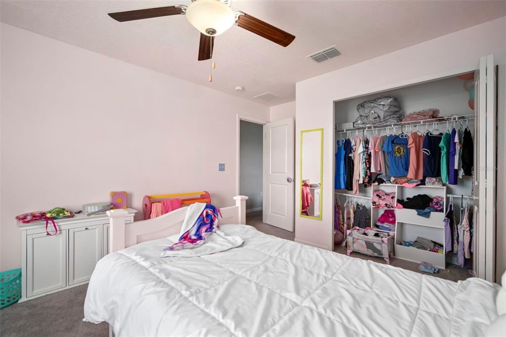 5430 Blue Azure Drive Wimauma, FL 33598 - Photo 38 of 46 a bedroom with bed and a chandelier