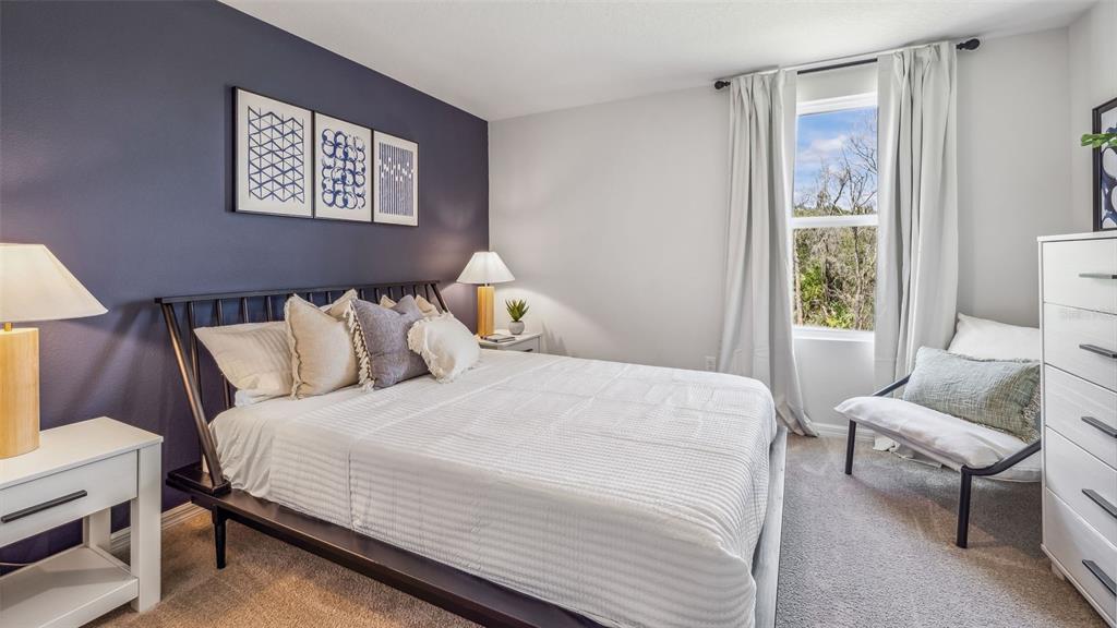 9939 Wimico Terrace Parrish, FL 34219 - Photo 11 of 32 a bedroom with a bed and a window