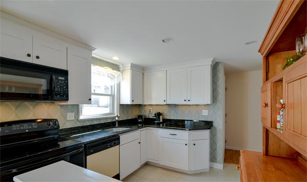 10 Spring Valley Road Natick, MA 01760 - Photo 4 of 17 a kitchen with granite countertop a sink a stove and cabinets