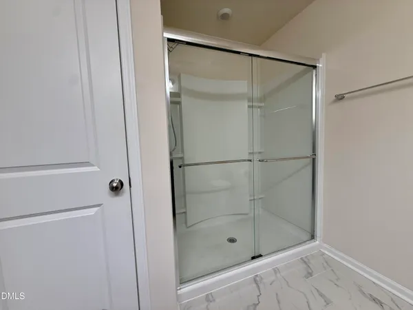 a bathroom with a glass shower door