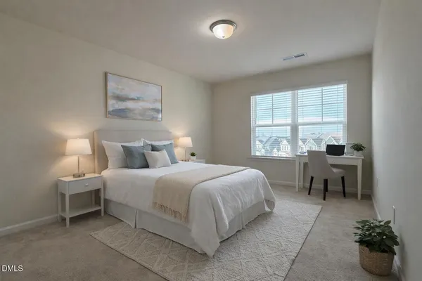 a bedroom with a bed and a table