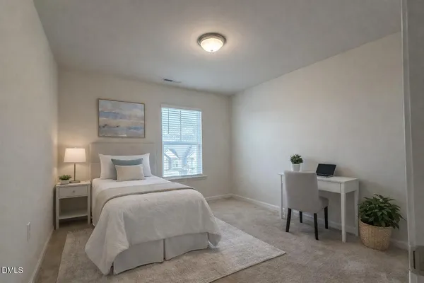 a bedroom with a bed and a chair