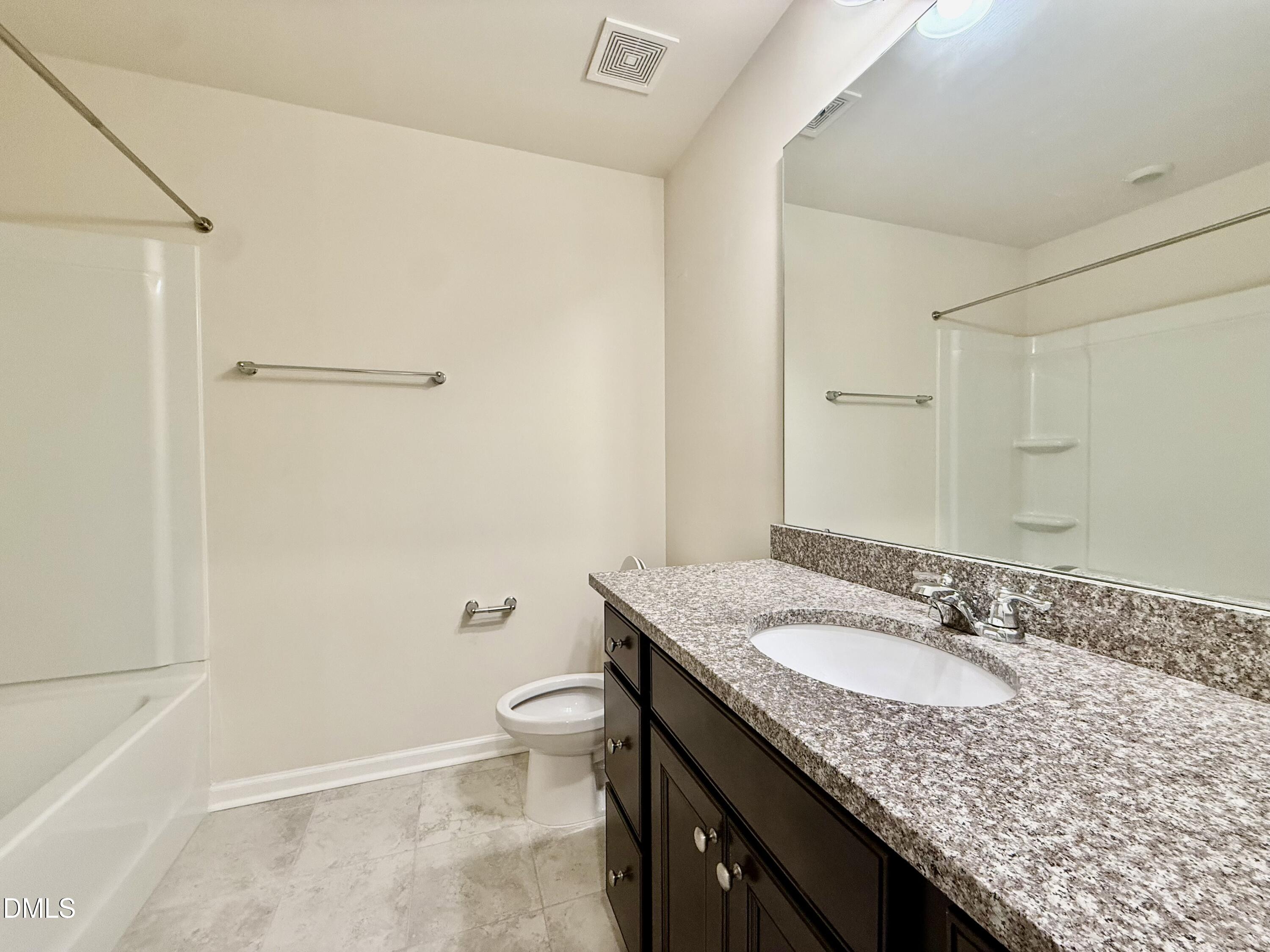 11 Rambler Lane Durham, NC 27703 - Photo 21 of 28 a bathroom with a granite countertop sink a toilet and a mirror