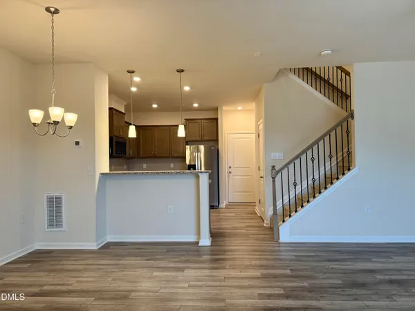 a view of a room with wooden floor and staircase