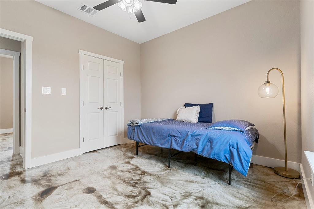 139 Kriston Lane Springtown, TX 76082 - Photo 15 of 39 Room featuring decorative concrete flooring, neutral wall paint, and white trim