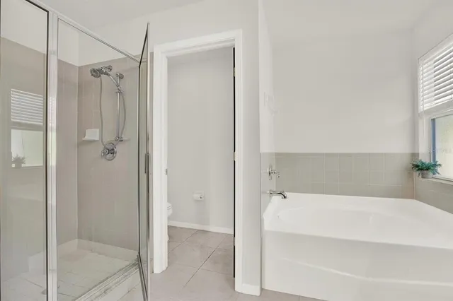 a spacious bathroom with a bathtub and shower