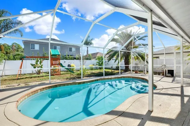 a view of a swimming pool with a patio