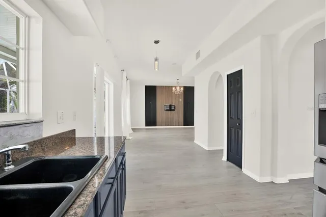 a kitchen with granite countertop a stove and a refrigerator