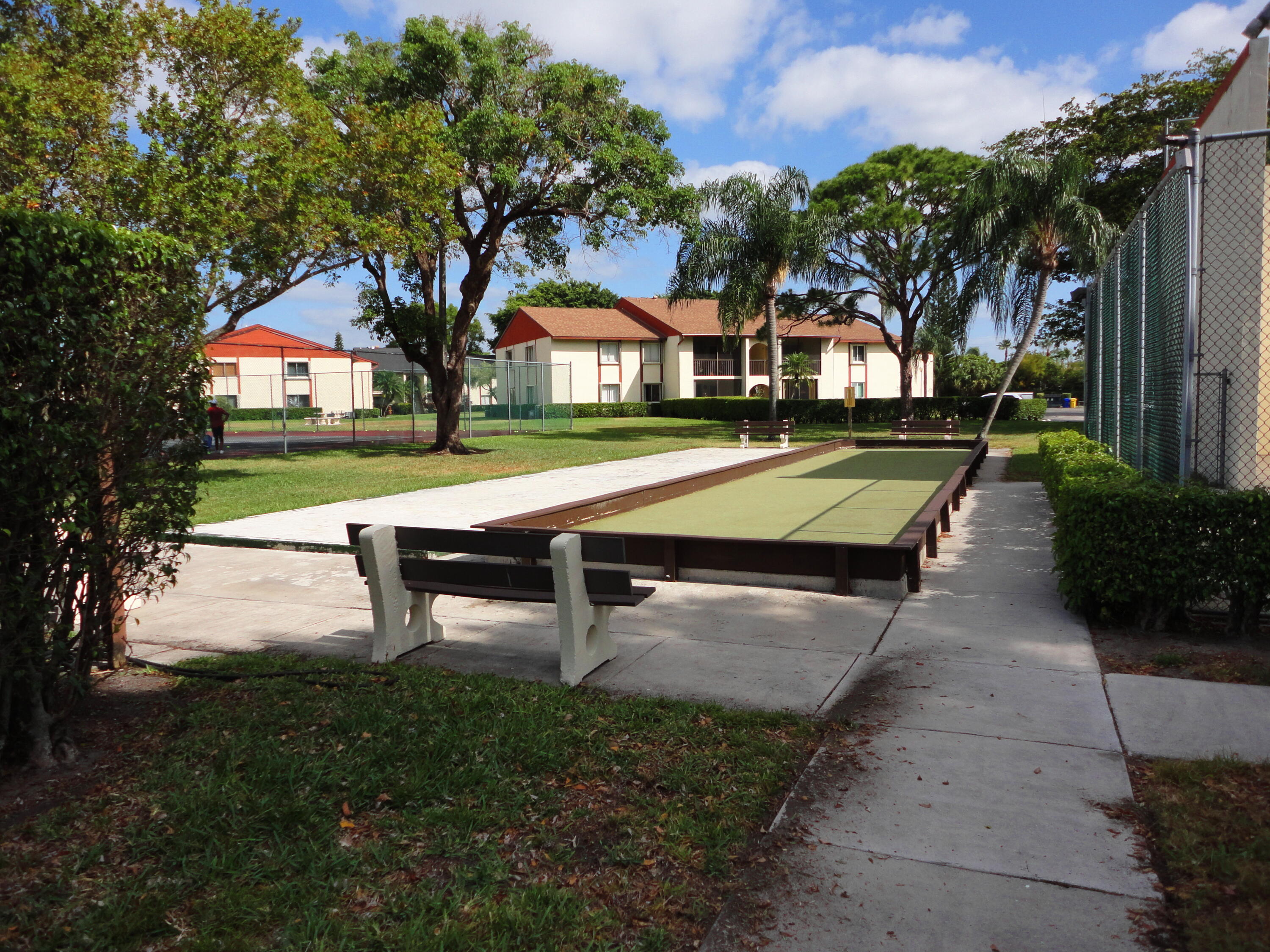 4695 Sable Pine Circle, Unit C2 West Palm Beach, FL 33417 - Photo 12 of 14 a swimming pool with outdoor seating and yard