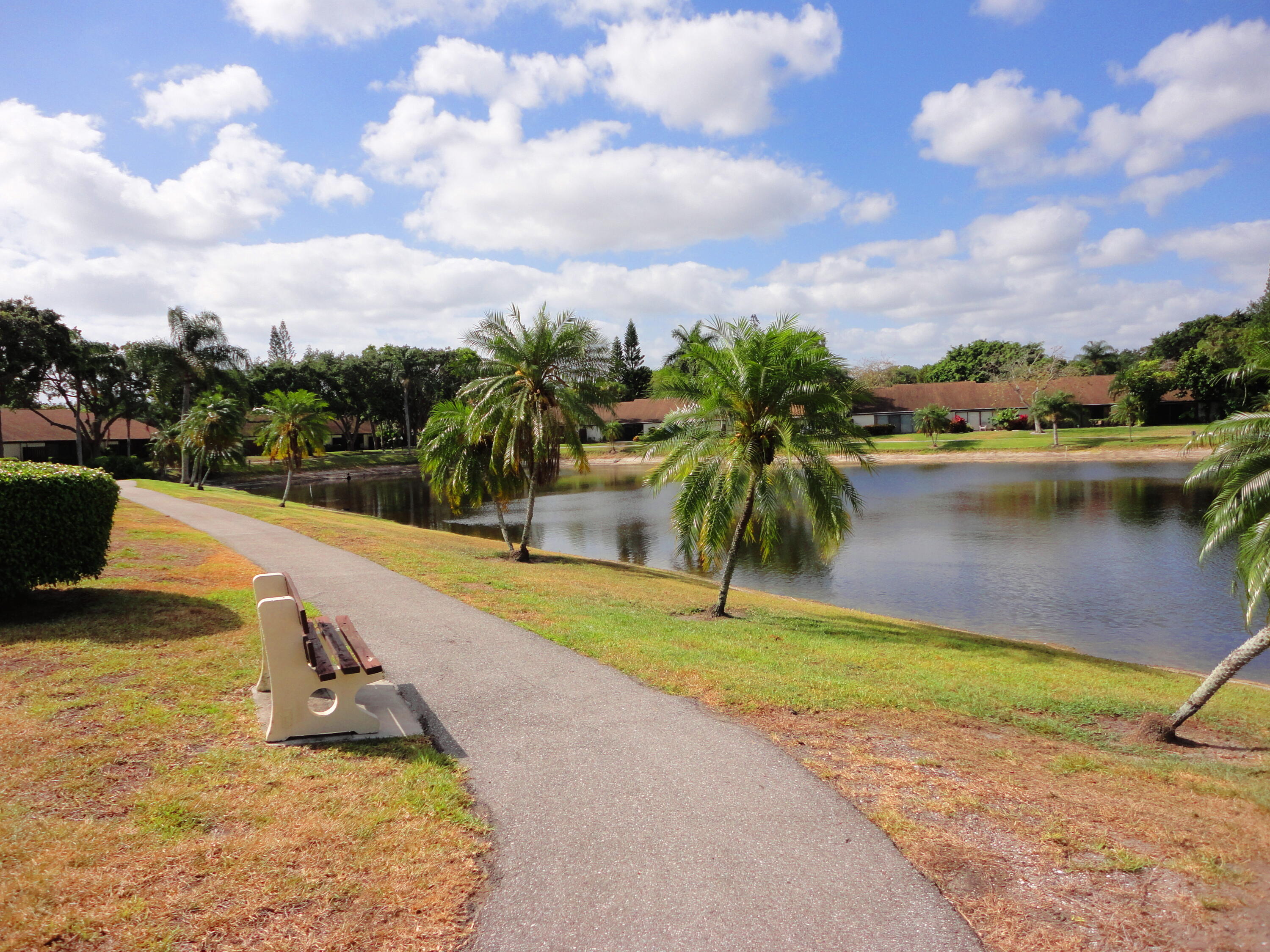 4695 Sable Pine Circle, Unit C2 West Palm Beach, FL 33417 - Photo 14 of 14 a view of a swimming pool with a yard