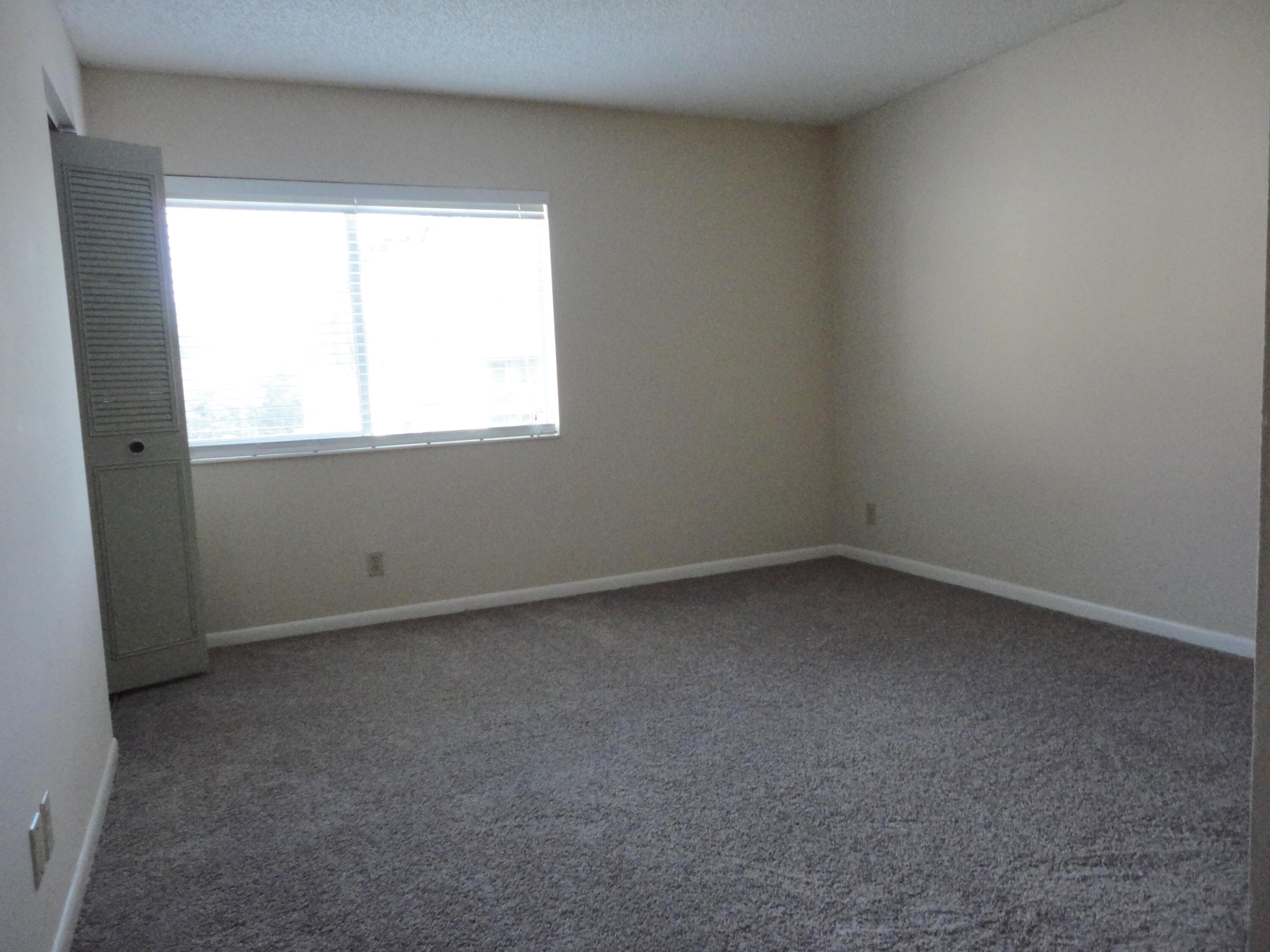 4695 Sable Pine Circle, Unit C2 West Palm Beach, FL 33417 - Photo 4 of 14 an empty room with a window