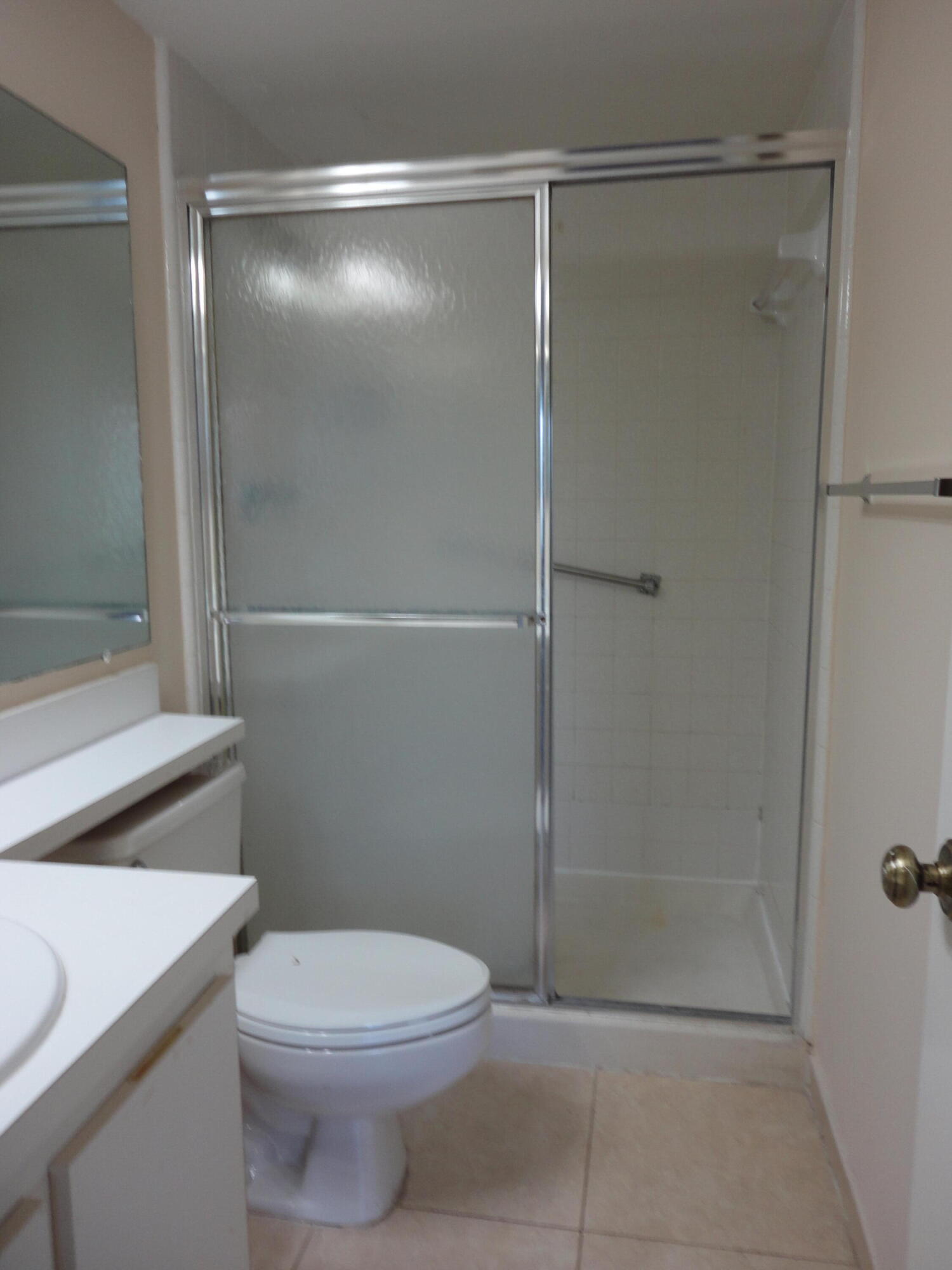 4695 Sable Pine Circle, Unit C2 West Palm Beach, FL 33417 - Photo 5 of 14 a bathroom with a shower a toilet and sink