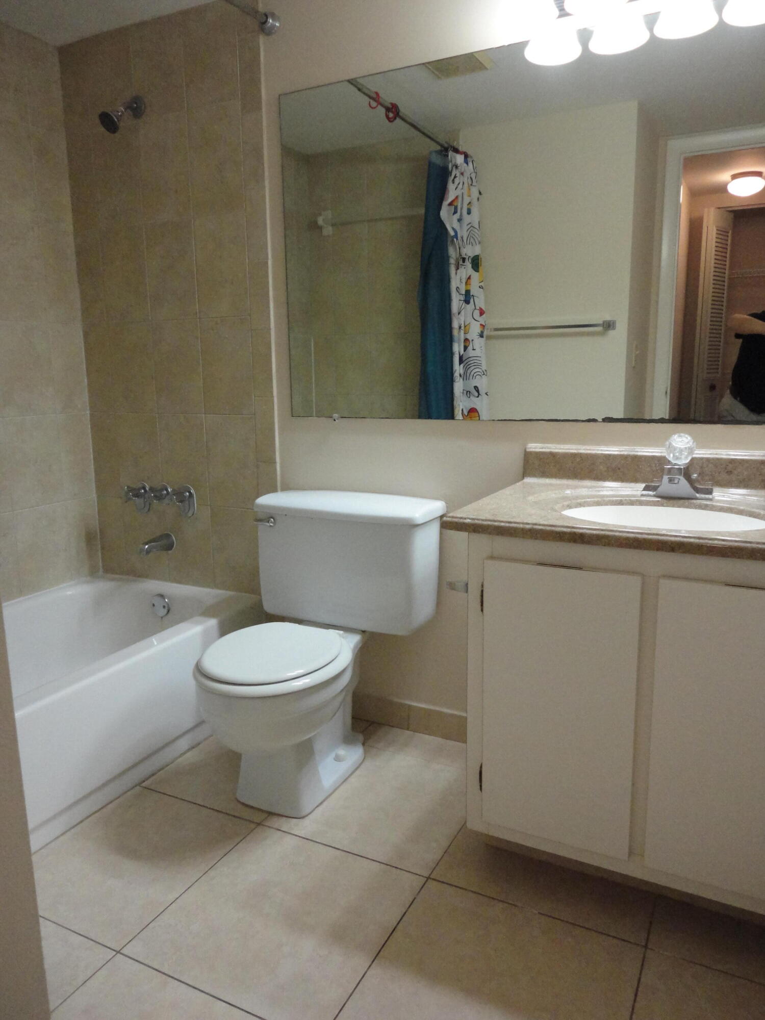 4695 Sable Pine Circle, Unit C2 West Palm Beach, FL 33417 - Photo 8 of 14 a bathroom with a toilet sink and mirror