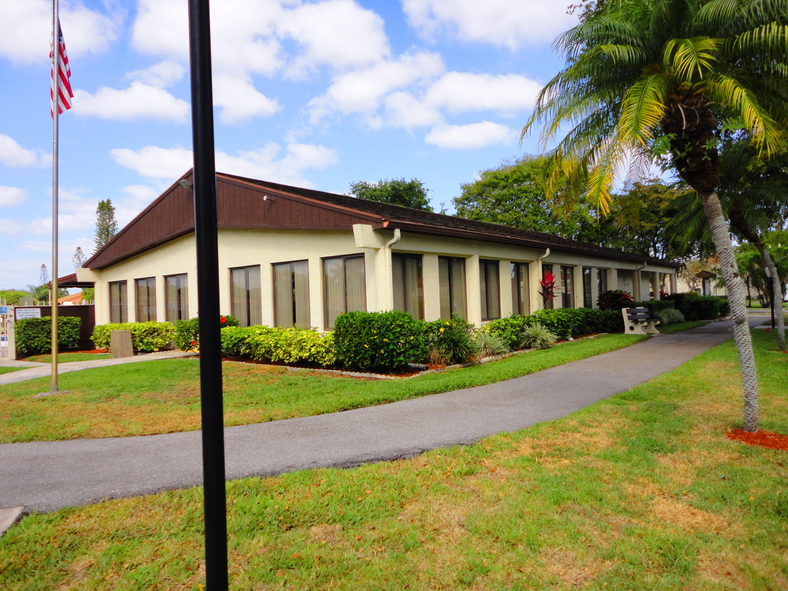 4695 Sable Pine Circle, Unit C2 West Palm Beach, FL 33417 - Photo 9 of 14 a front view of house with yard and green space