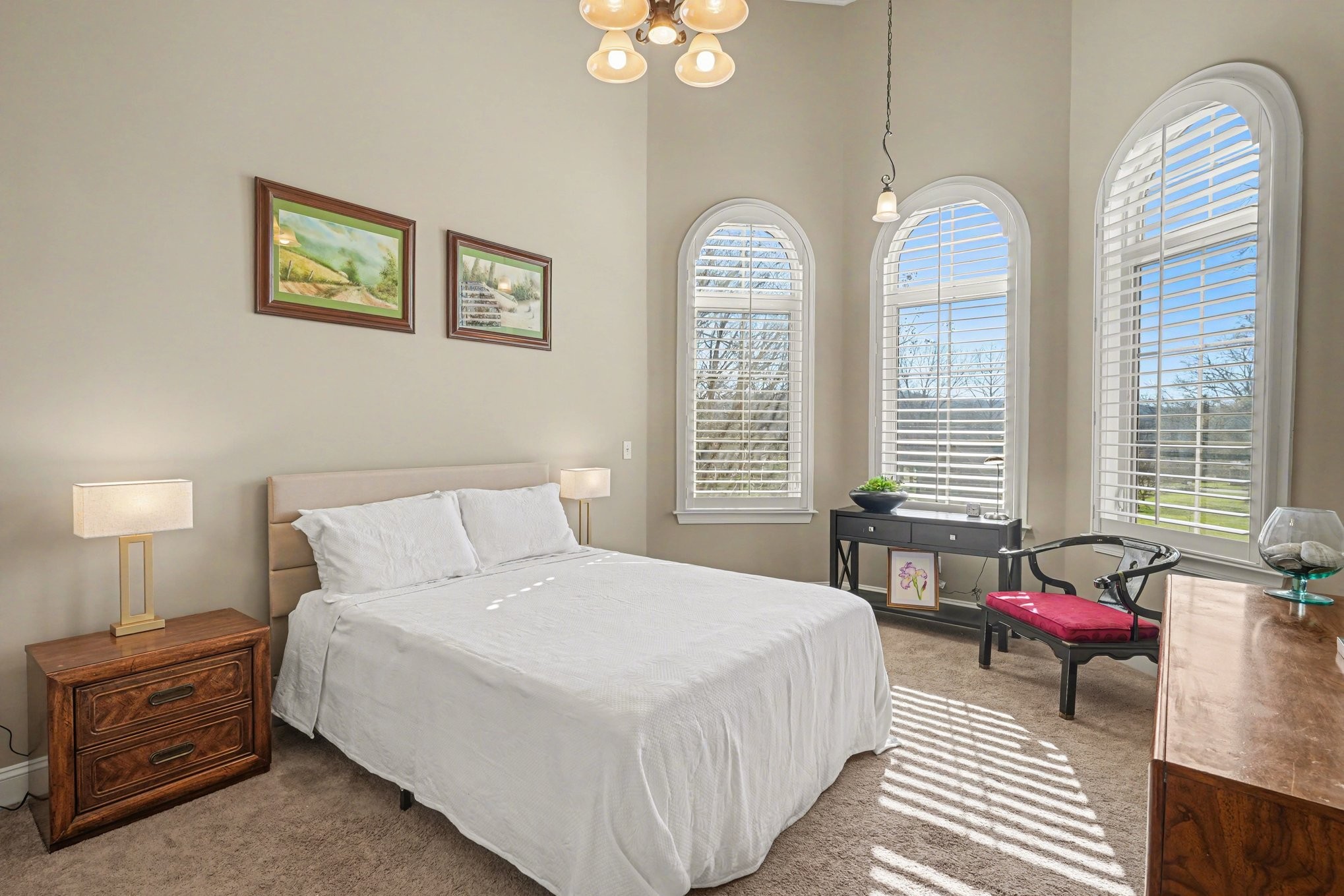 5094 Moss Road Nashville, TN 37221 - Photo 27 of 29 a spacious bedroom with two beds and a chandelier