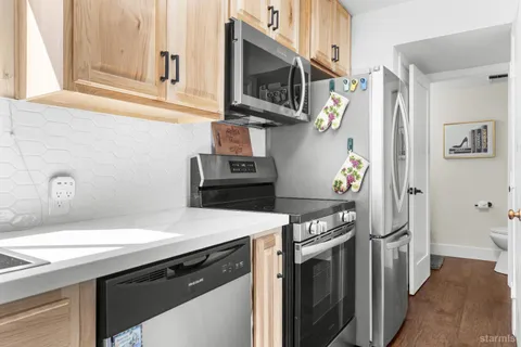 a kitchen with stainless steel appliances a stove and a refrigerator