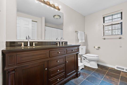 203 West Cruikshank Road Butler, PA 16002 - Photo 20 of 32 a bathroom with a toilet a sink and mirror