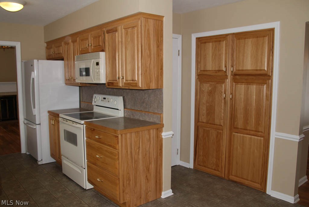 208 Harmon Road Aurora, OH 44202 - Photo 13 of 35 Another view of the kitchen and pantry with a door leading to the basement.