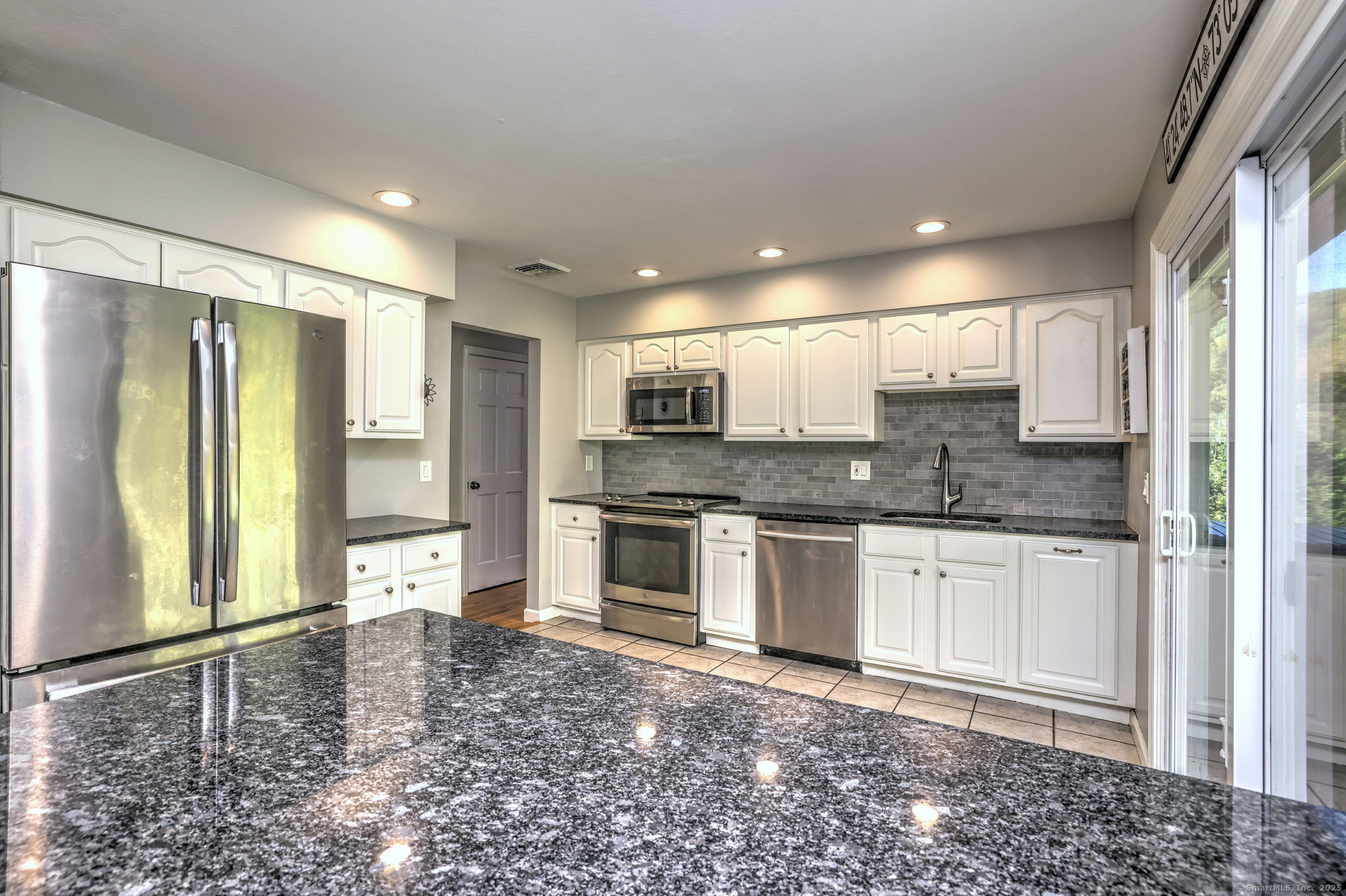 78 Hillside Drive Beacon Falls, CT 06403 - Photo 11 of 40 a kitchen with stainless steel appliances granite countertop a stove a sink and a refrigerator