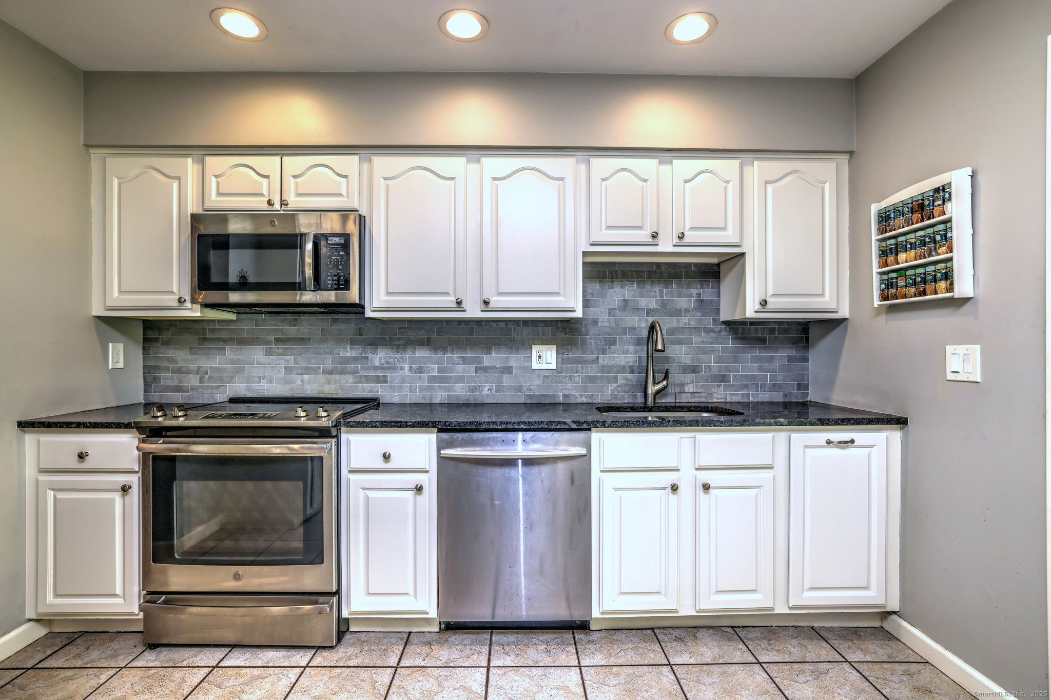 78 Hillside Drive Beacon Falls, CT 06403 - Photo 14 of 40 a kitchen with stainless steel appliances granite countertop a stove a microwave and cabinets