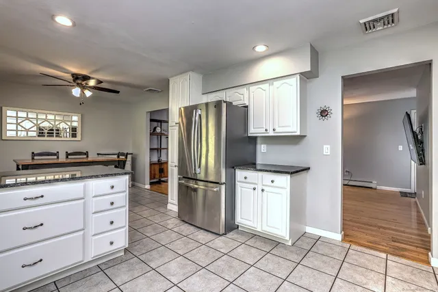 a kitchen with granite countertop cabinets and stainless steel appliances
