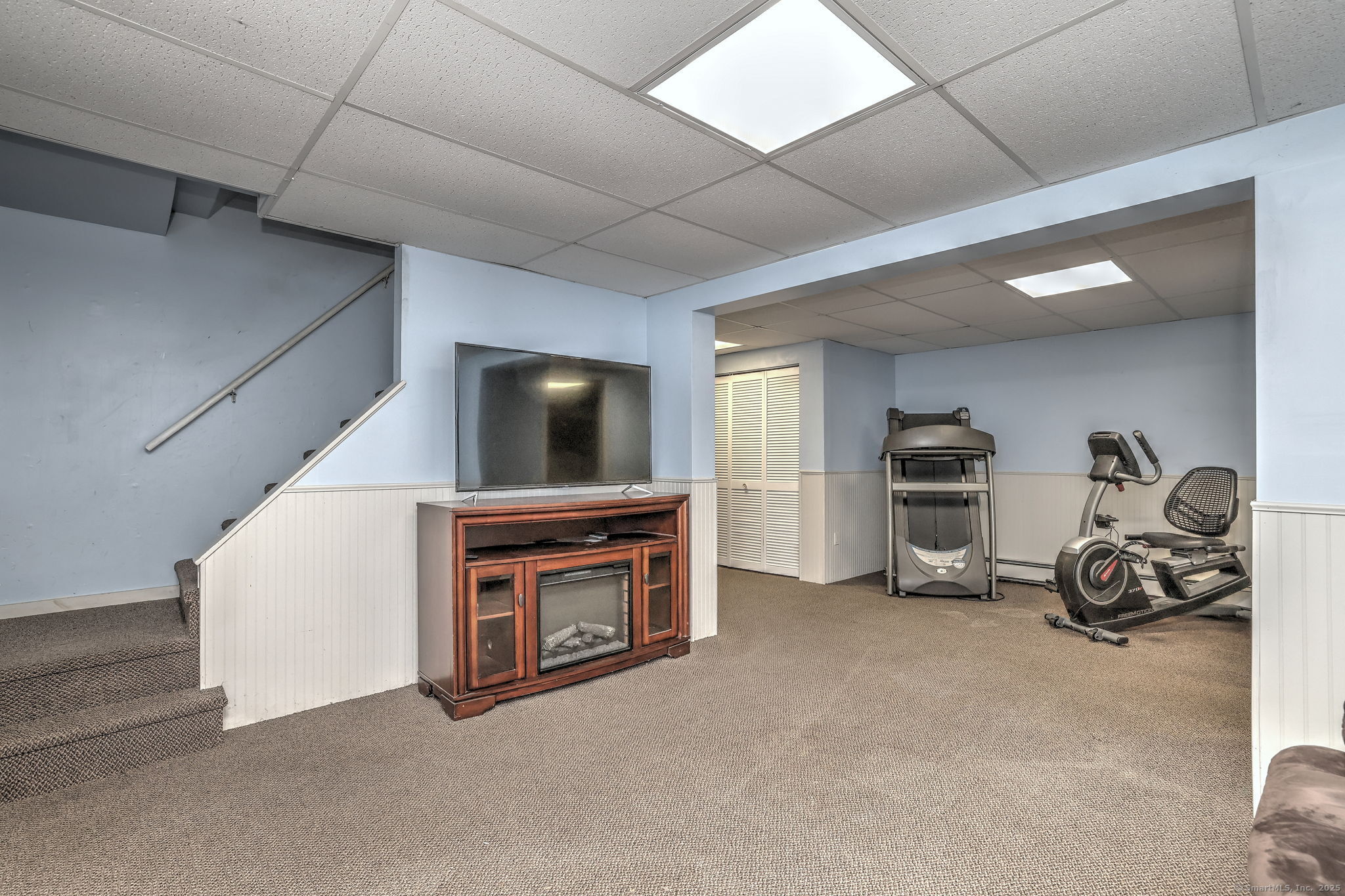 78 Hillside Drive Beacon Falls, CT 06403 - Photo 30 of 40 a living room with furniture a flat screen tv and a fireplace