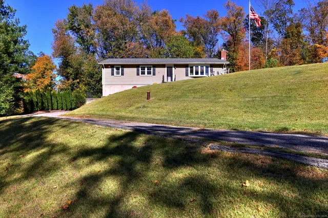 a view of swimming pool of a house with a yard