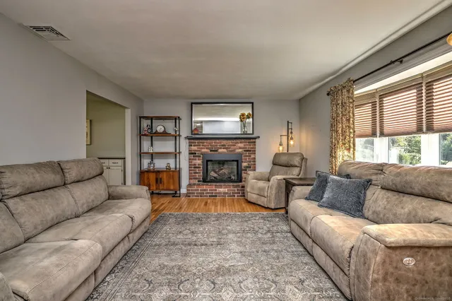 a living room with furniture flat screen tv and a fireplace