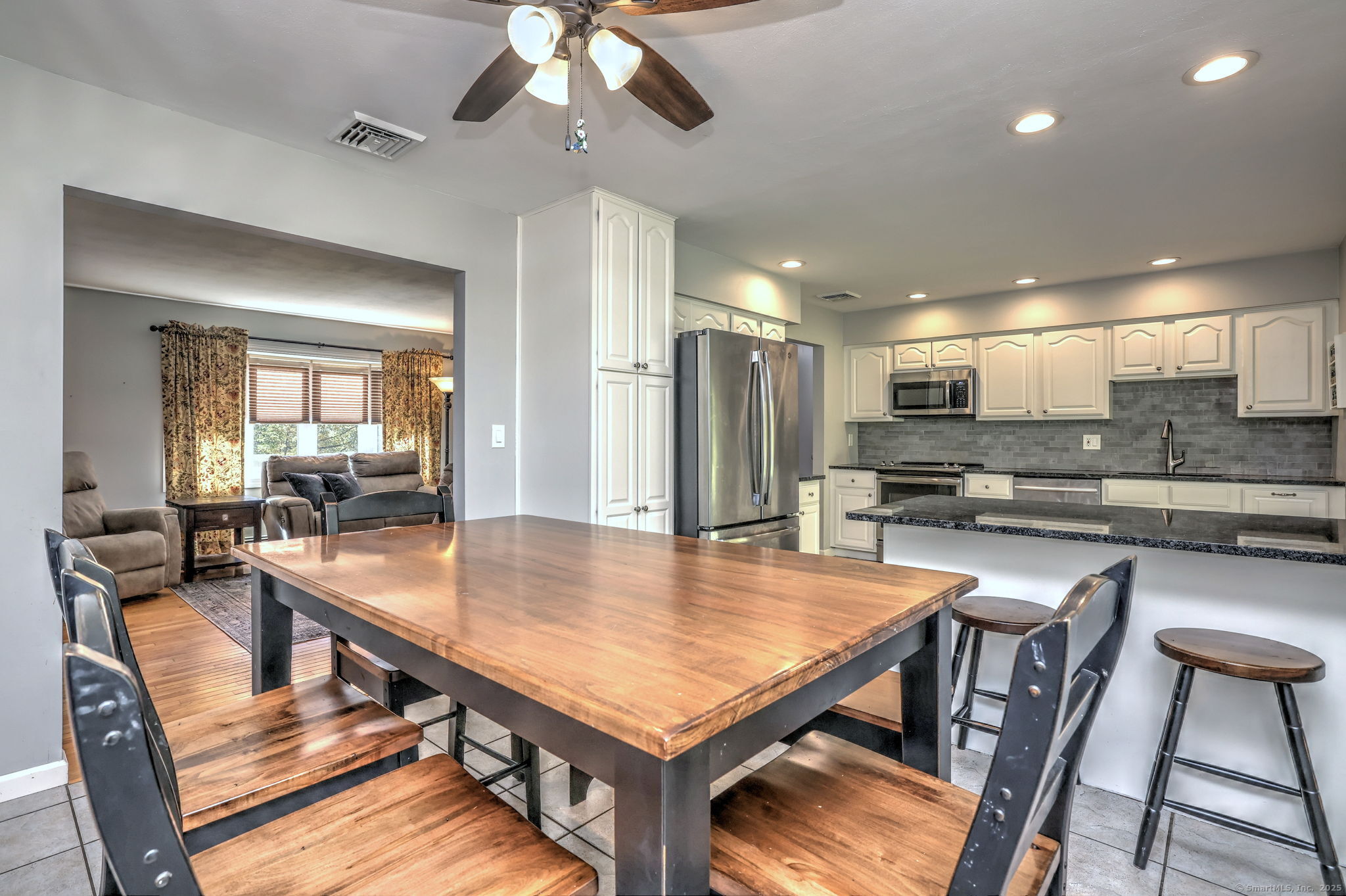 78 Hillside Drive Beacon Falls, CT 06403 - Photo 9 of 40 a kitchen with stainless steel appliances kitchen island granite countertop a dining table chairs and refrigerator