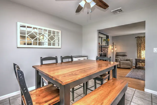 a room with furniture pool table and wooden floor