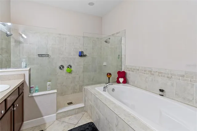 a bathroom with a tub sink and a mirror