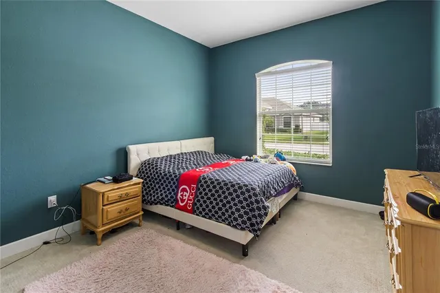 a bedroom with a bed and window